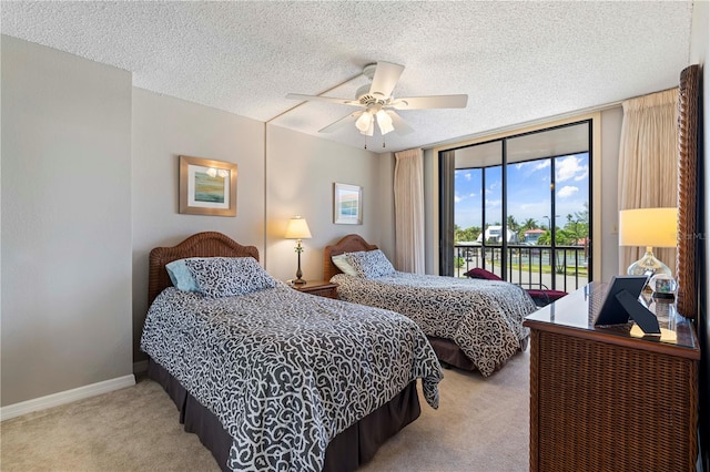 carpeted bedroom featuring a textured ceiling, ceiling fan, and access to exterior