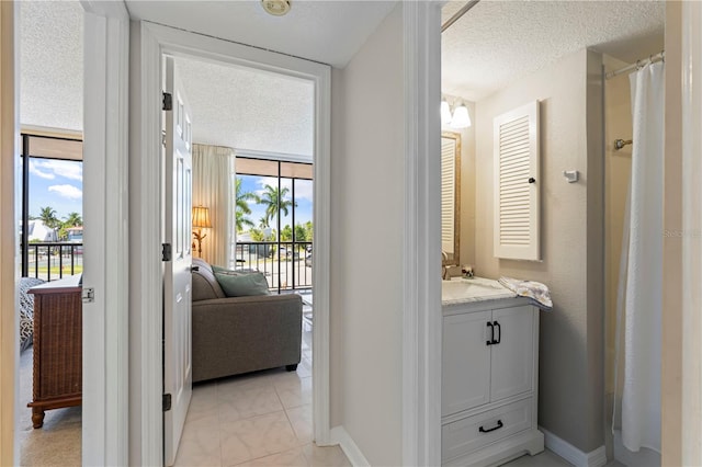 interior space with a wealth of natural light, a textured ceiling, and sink