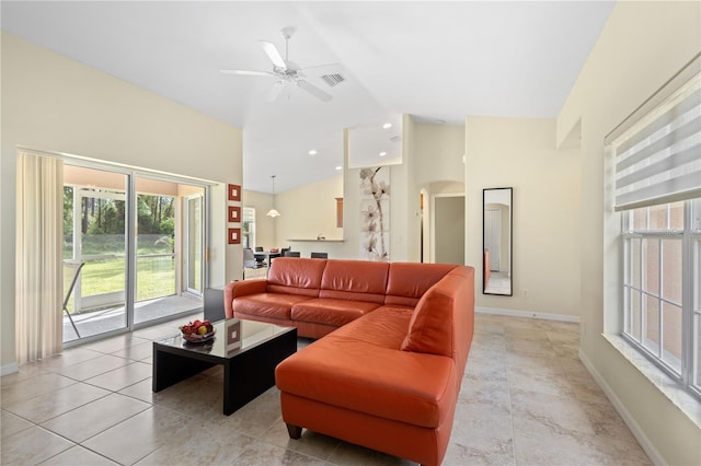 tiled living room featuring lofted ceiling and ceiling fan