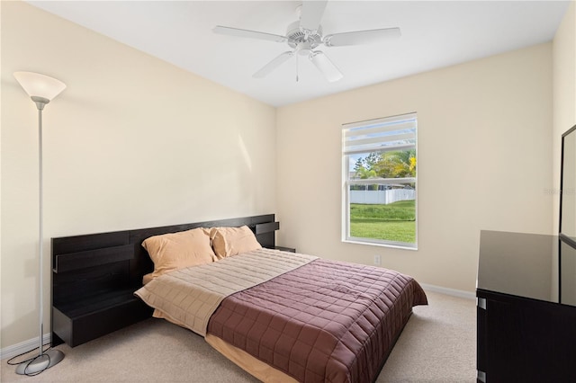 bedroom with light colored carpet and ceiling fan