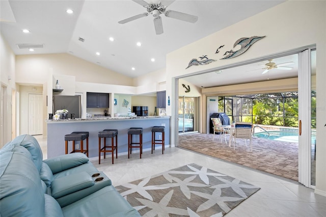 tiled living room featuring vaulted ceiling and ceiling fan