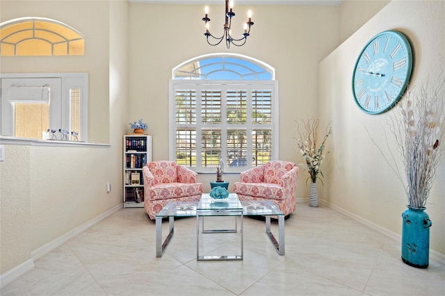 living area with a towering ceiling and an inviting chandelier