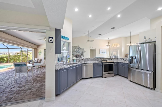 kitchen with gray cabinets, appliances with stainless steel finishes, sink, and lofted ceiling