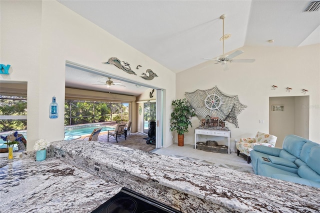 living room with light colored carpet, vaulted ceiling, and ceiling fan