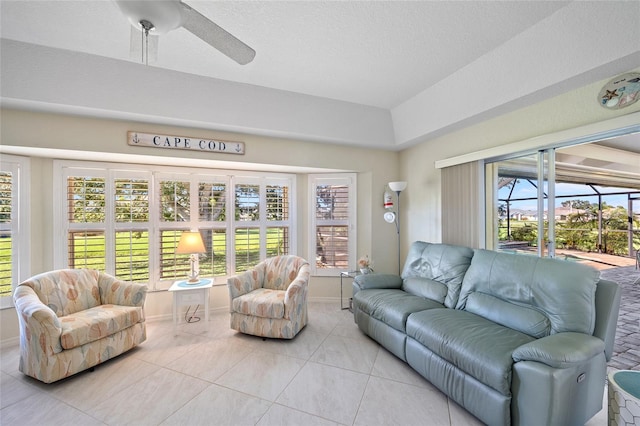 living room featuring ceiling fan and light tile patterned floors