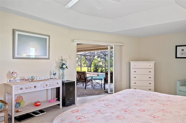 tiled bedroom with access to exterior, ceiling fan, and a tray ceiling