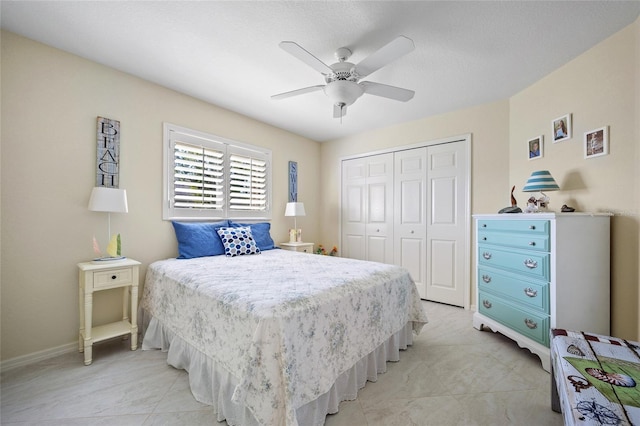 bedroom with ceiling fan and a closet