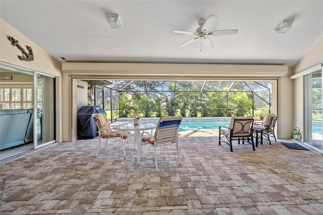 view of patio / terrace featuring grilling area, a lanai, and ceiling fan