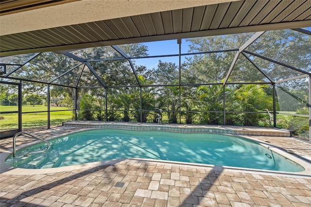 view of swimming pool with glass enclosure and a patio area