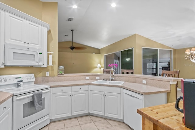 kitchen featuring sink, vaulted ceiling, white cabinetry, and white appliances