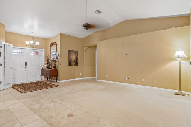 carpeted entryway featuring lofted ceiling and ceiling fan with notable chandelier