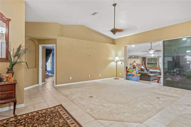 living room with vaulted ceiling, ceiling fan, and light tile patterned floors