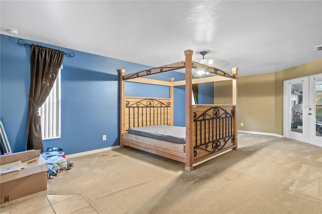 carpeted bedroom with french doors, ceiling fan, and access to outside