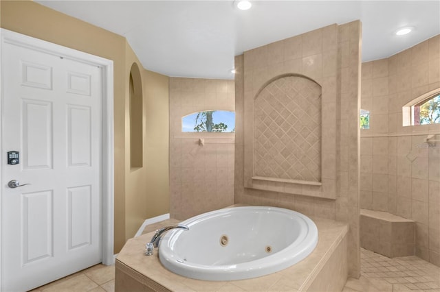 bathroom with independent shower and bath and tile patterned flooring