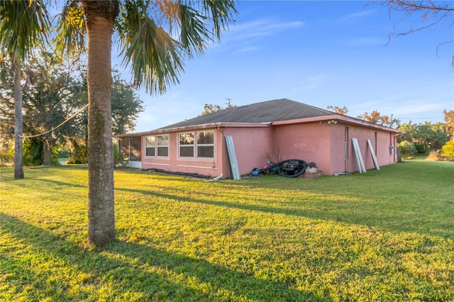 view of side of property with a lawn