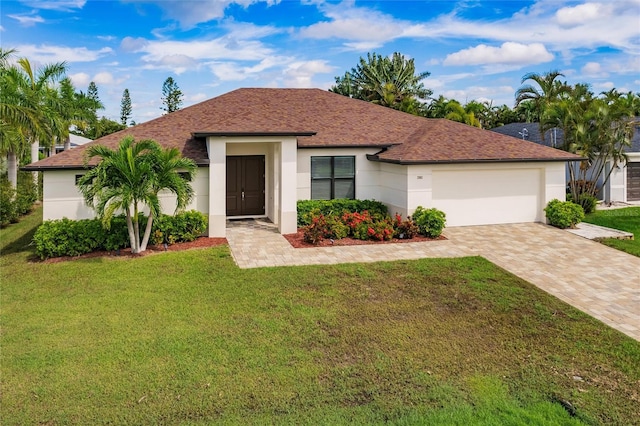 view of front of property featuring a front yard and a garage