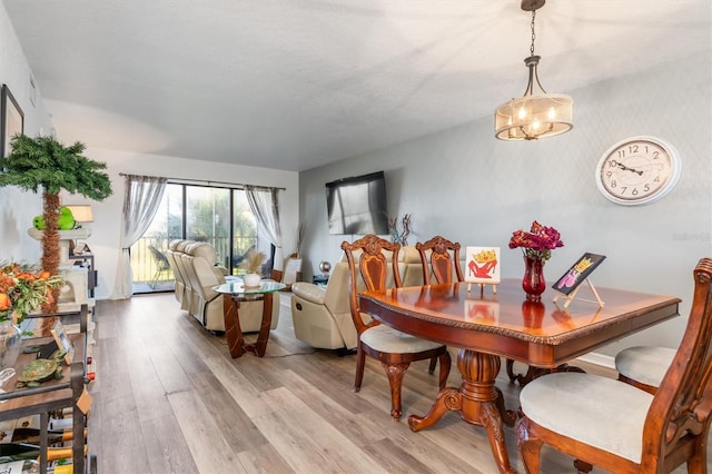 dining room featuring light hardwood / wood-style flooring and a chandelier