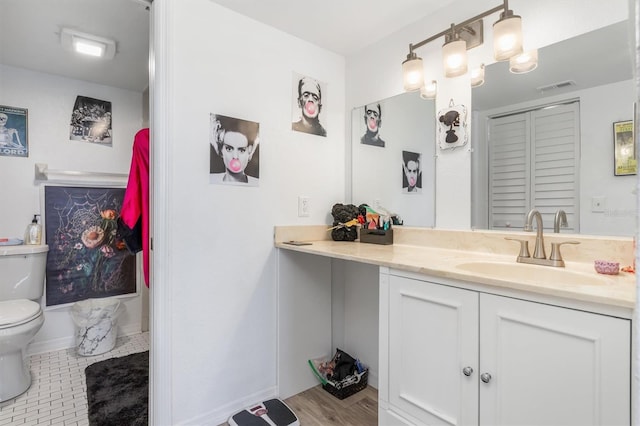 bathroom featuring vanity, toilet, and tile patterned floors