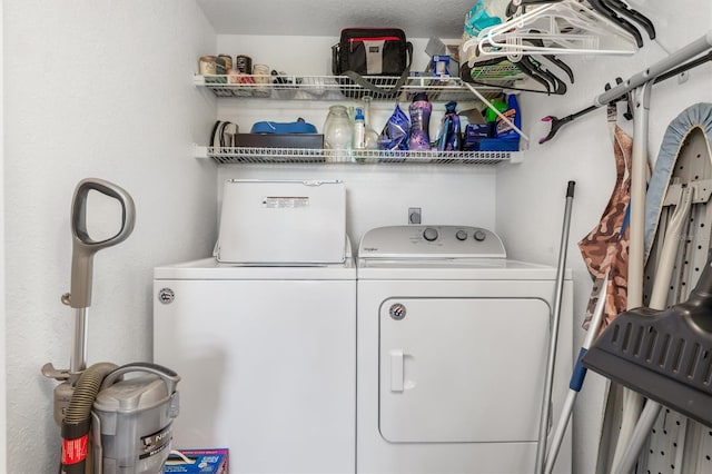 laundry area featuring a textured ceiling and washing machine and dryer