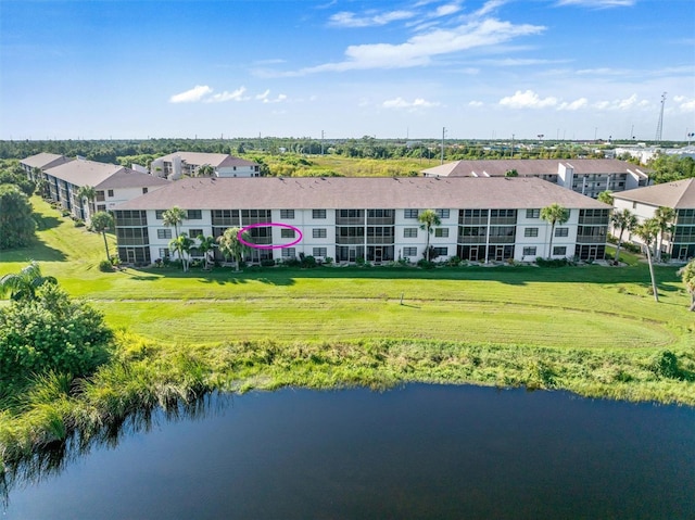 rear view of property with a lawn and a water view