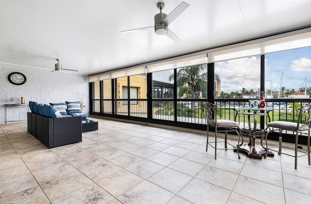 sunroom / solarium featuring ceiling fan