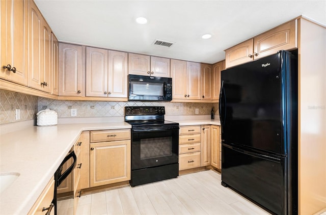 kitchen featuring black appliances, light brown cabinets, light hardwood / wood-style flooring, and tasteful backsplash