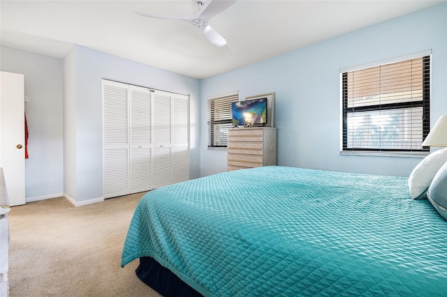 carpeted bedroom with a closet and ceiling fan