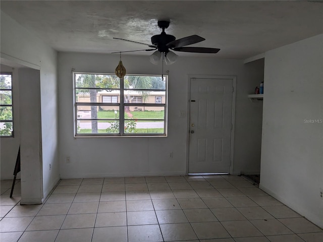 tiled foyer entrance with ceiling fan