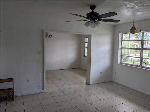 empty room featuring ceiling fan and light tile patterned floors