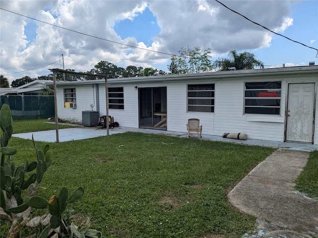 back of house with a yard, a patio area, and central air condition unit