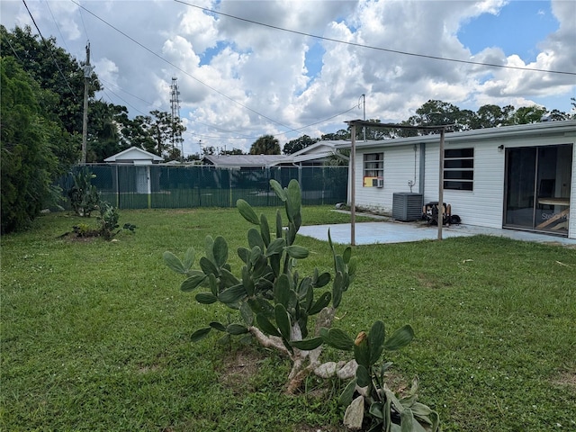 view of yard with central air condition unit and a patio area