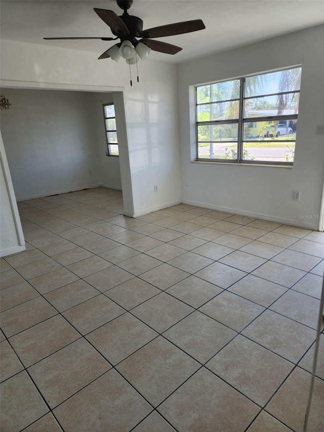 spare room with light tile patterned flooring and ceiling fan