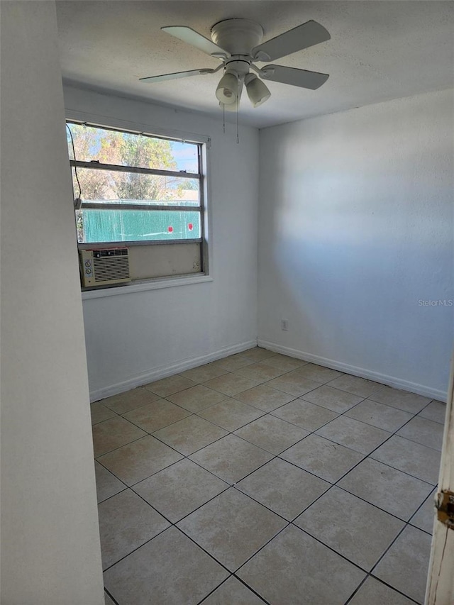 tiled spare room with cooling unit and ceiling fan