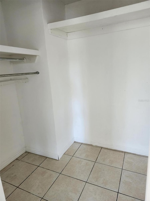 spacious closet with light tile patterned floors