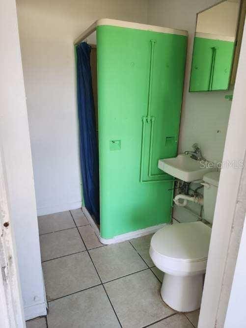 bathroom with tile patterned floors, toilet, and sink