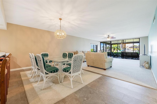 carpeted dining space with ceiling fan with notable chandelier