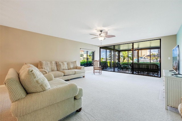 carpeted living room featuring ceiling fan