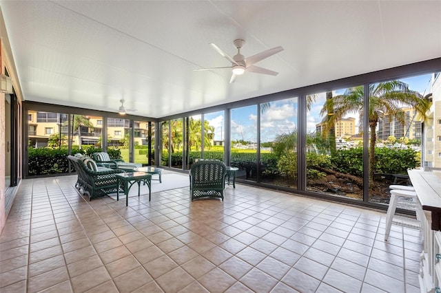 unfurnished sunroom with ceiling fan