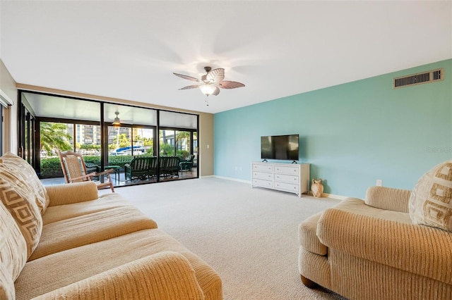 carpeted living room with ceiling fan