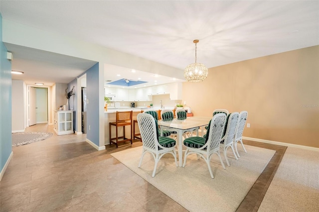 dining room with a notable chandelier and sink