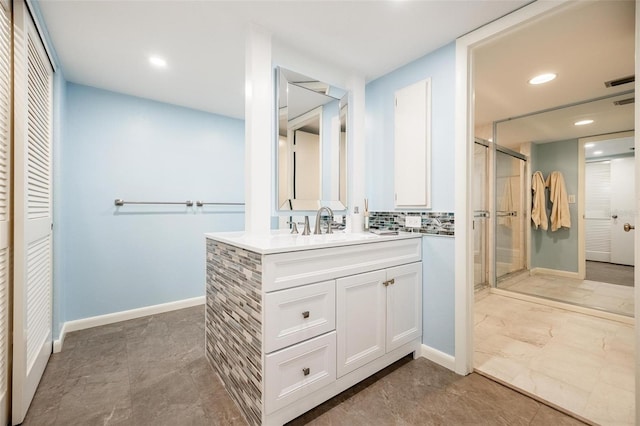 bathroom with walk in shower, decorative backsplash, and vanity