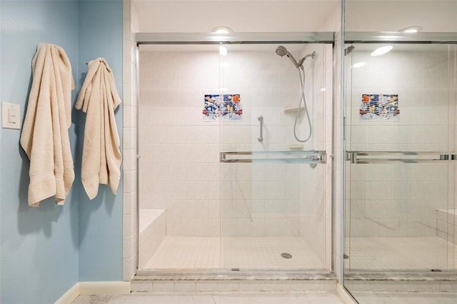 bathroom with a shower with shower door