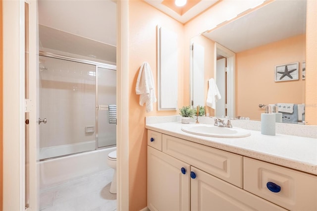 full bathroom featuring tile patterned flooring, enclosed tub / shower combo, vanity, and toilet