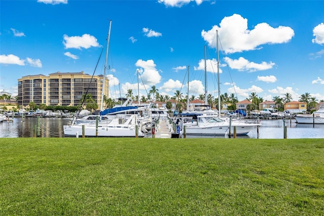 dock area featuring a lawn and a water view