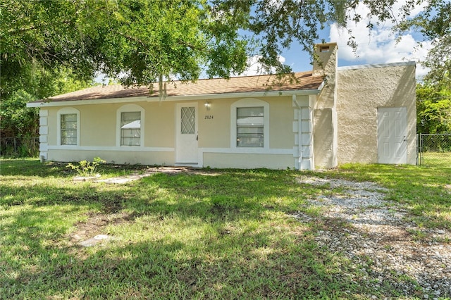 ranch-style house with a front lawn