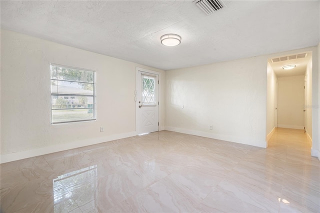 empty room with a textured ceiling