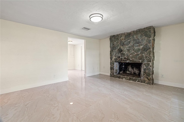 unfurnished living room with a fireplace and a textured ceiling