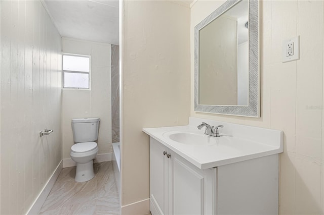 bathroom with wood walls, vanity, and toilet