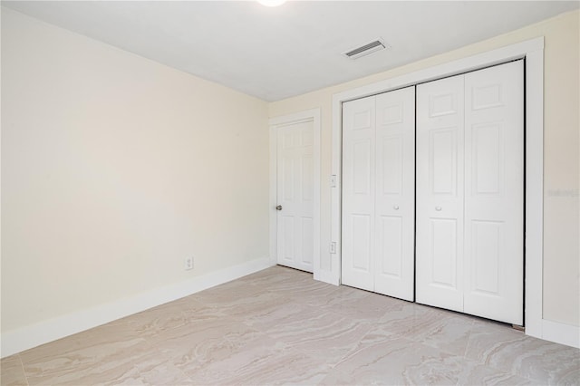 unfurnished bedroom with a closet