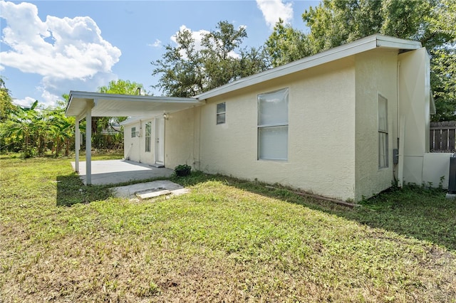 back of house featuring a patio area and a yard